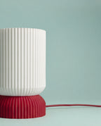 Close-up of the Luma lamp shade and ribbed red base
