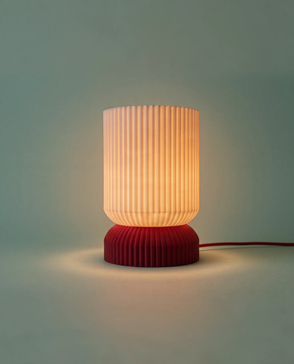 Luma table lamp lit at night on a side table