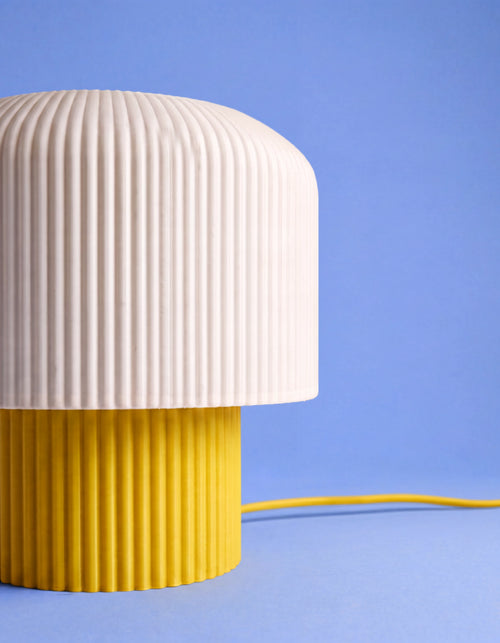 Close-up of the Nubo lamp shade and ribbed yellow base