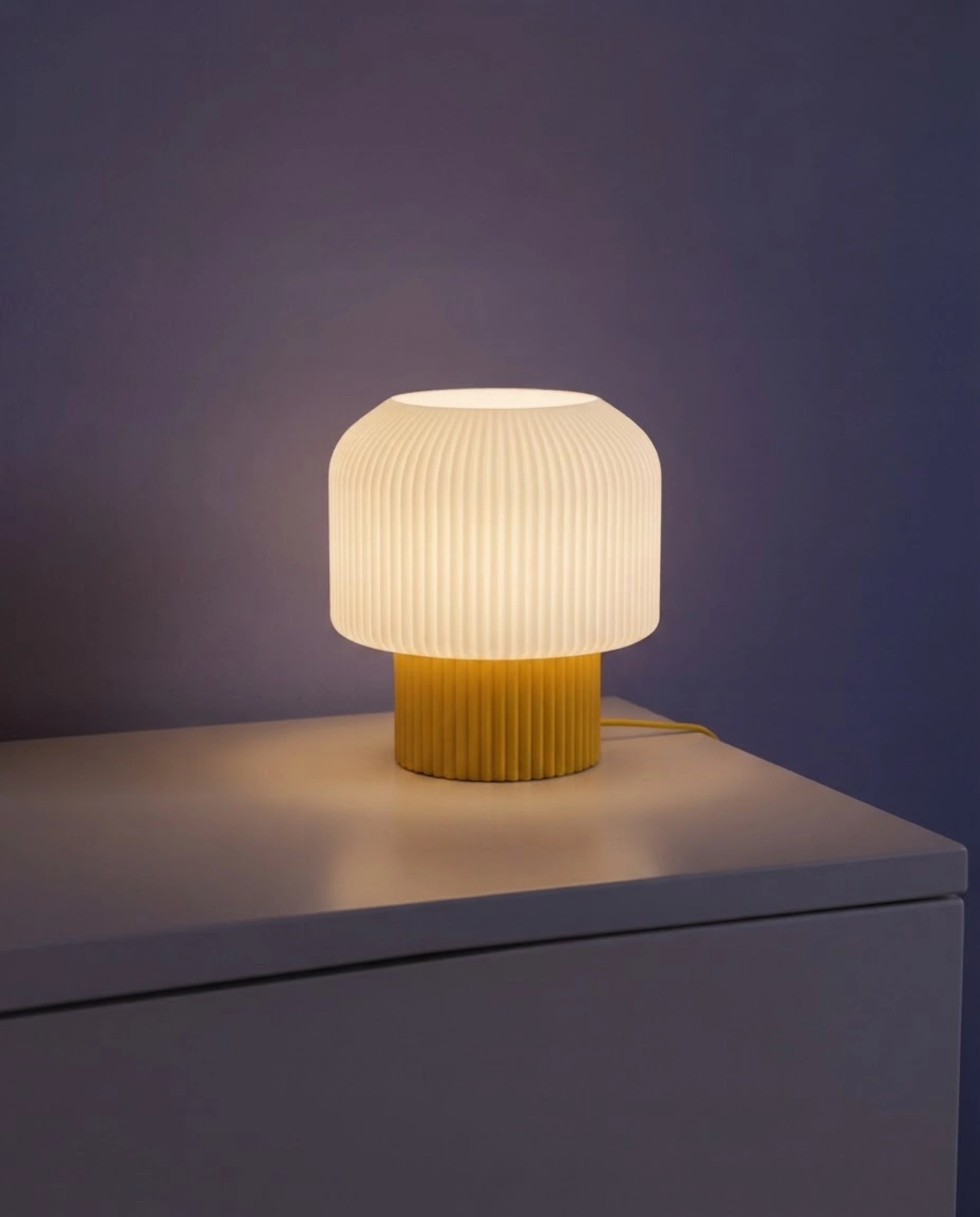 Nubo table lamp lit at night on a side table