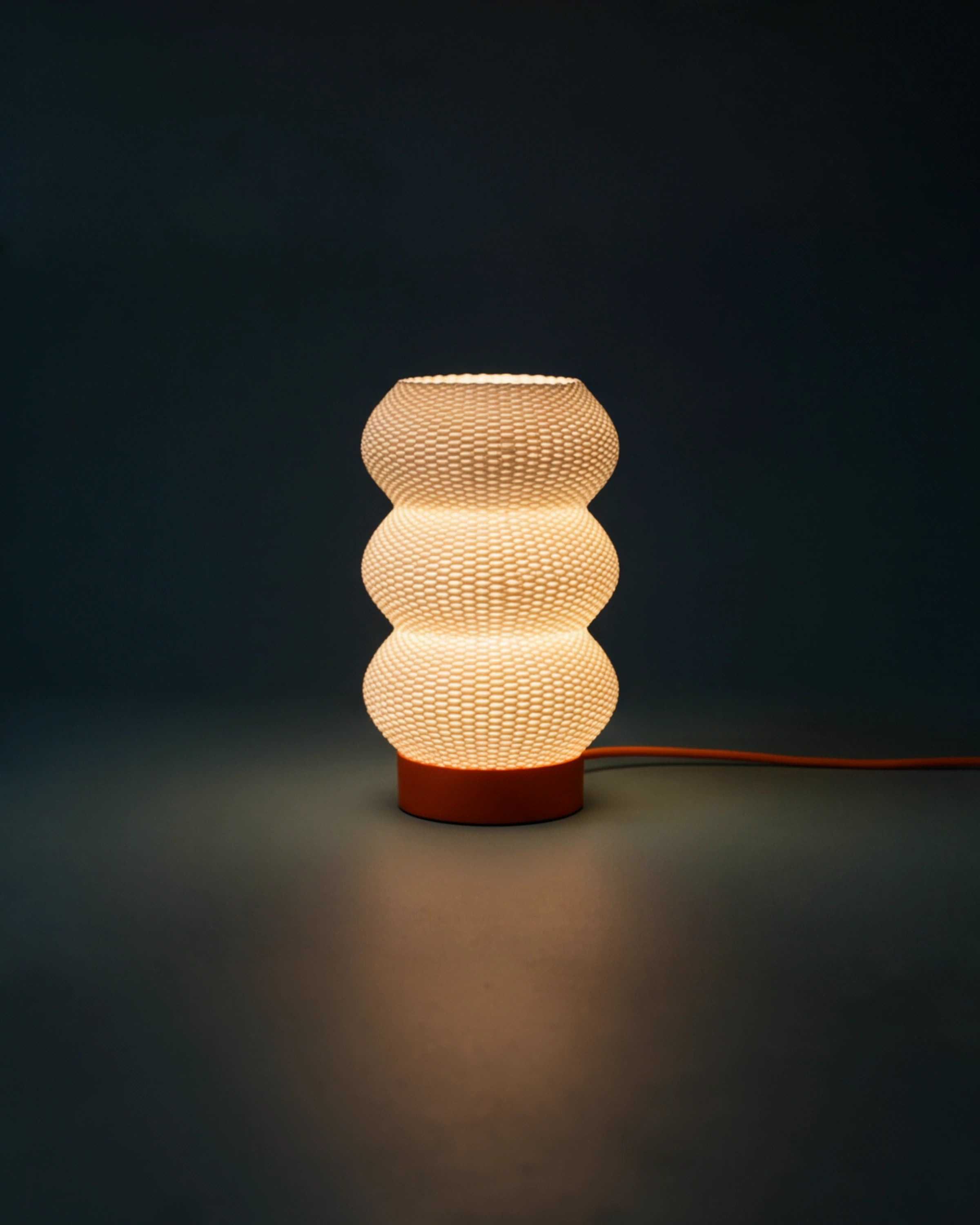 Soma table lamp lit at night on a side table