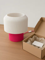 A pink Nubo next to its gift box