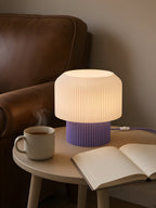 Nubo in Purple: at home, next to a reading chair