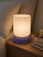 Luma switched on, on a crowded bedside table