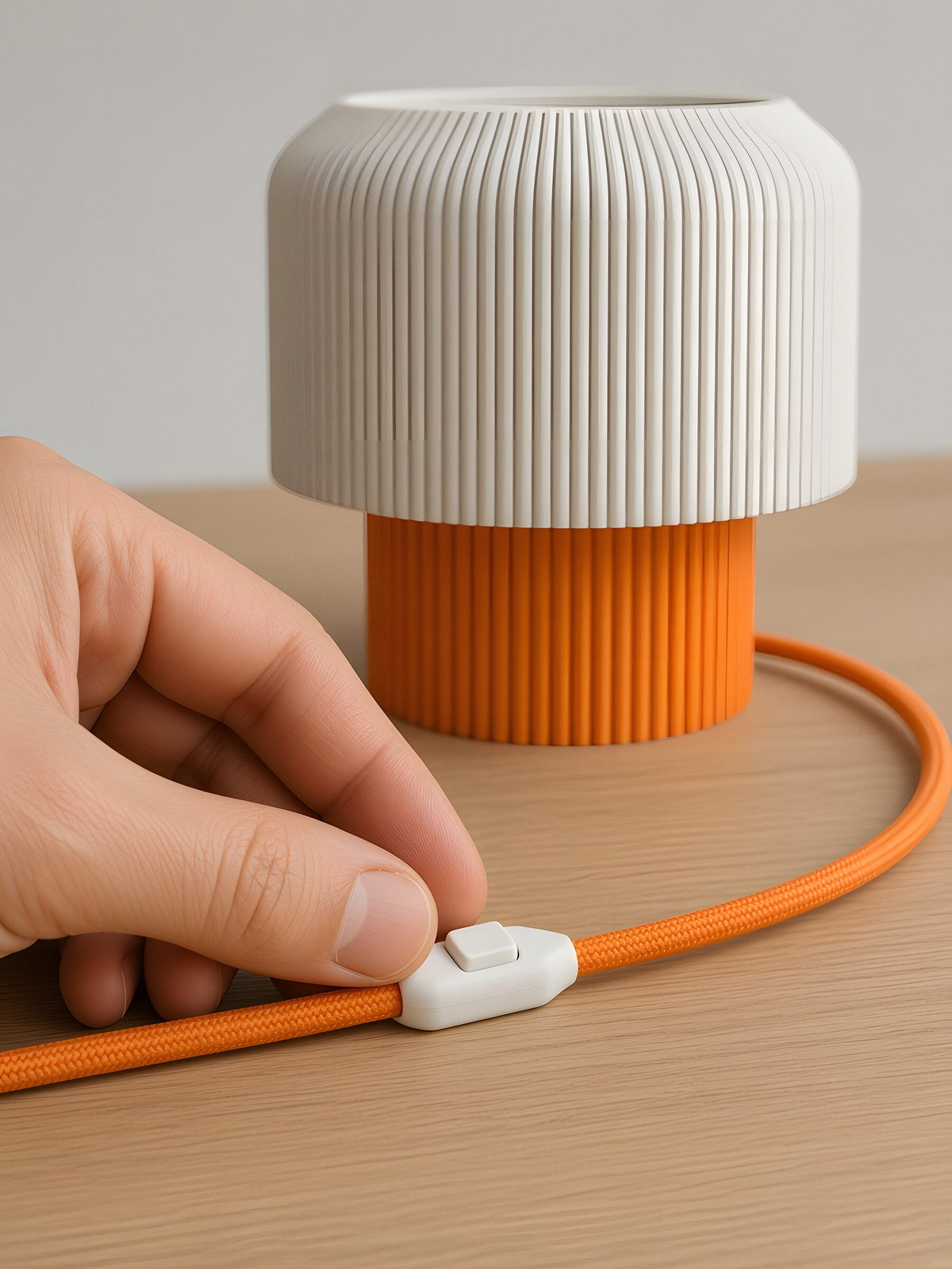 Nubo in Orange: white switch on the braided cable