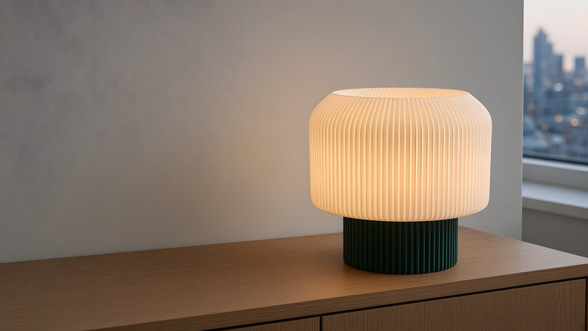Nubo in green switched on, on a wooden sideboard