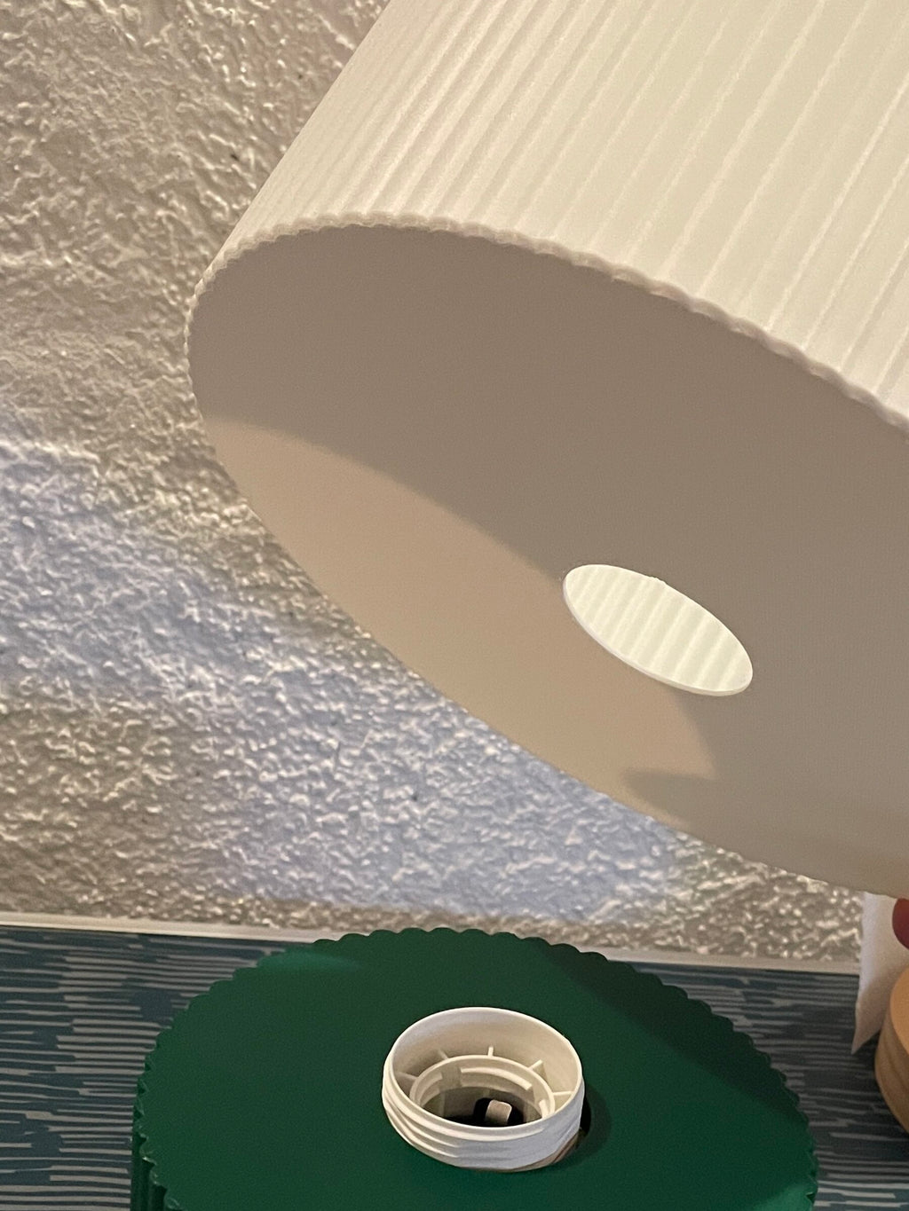 The shade goes on the base