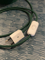 The white switch and the plug on the braided cable