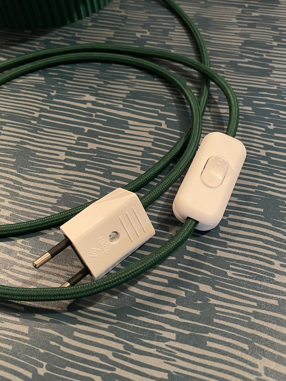 The white switch and the plug on the braided cable